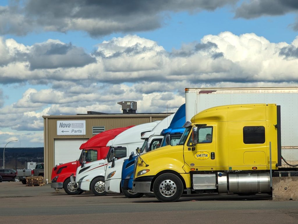pexels-photo-16663692 Parked semi-trucks of various colors outside a Nova Parts warehouse in Truro, NS.